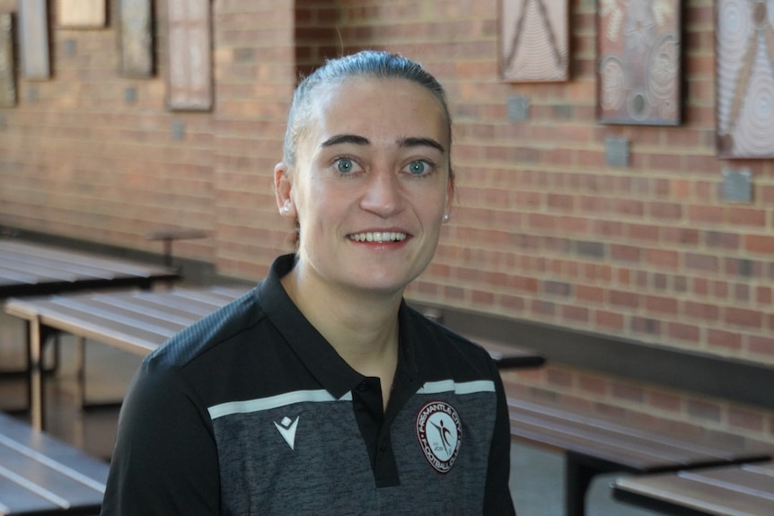 Fremantle City NPLW player, and Notre Dame PhD candidate, Mikayla Lyons sits in a common area at Notre Dame University