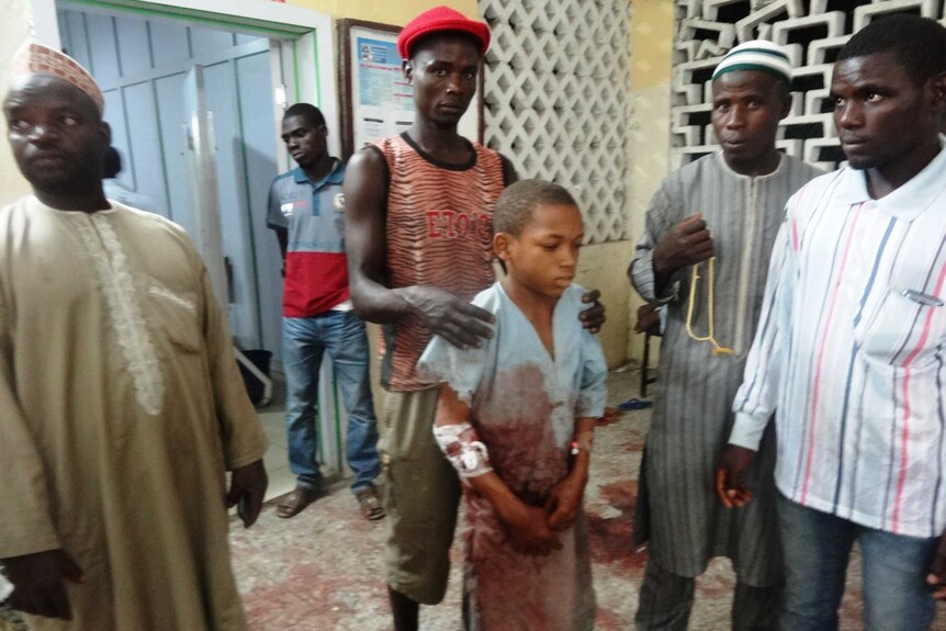 A young boy injured in the twin suicide blast at Kano central mosque arrives at the accident and emergency ward of the Nassarawa Specialist Hospital on November 28, 2014