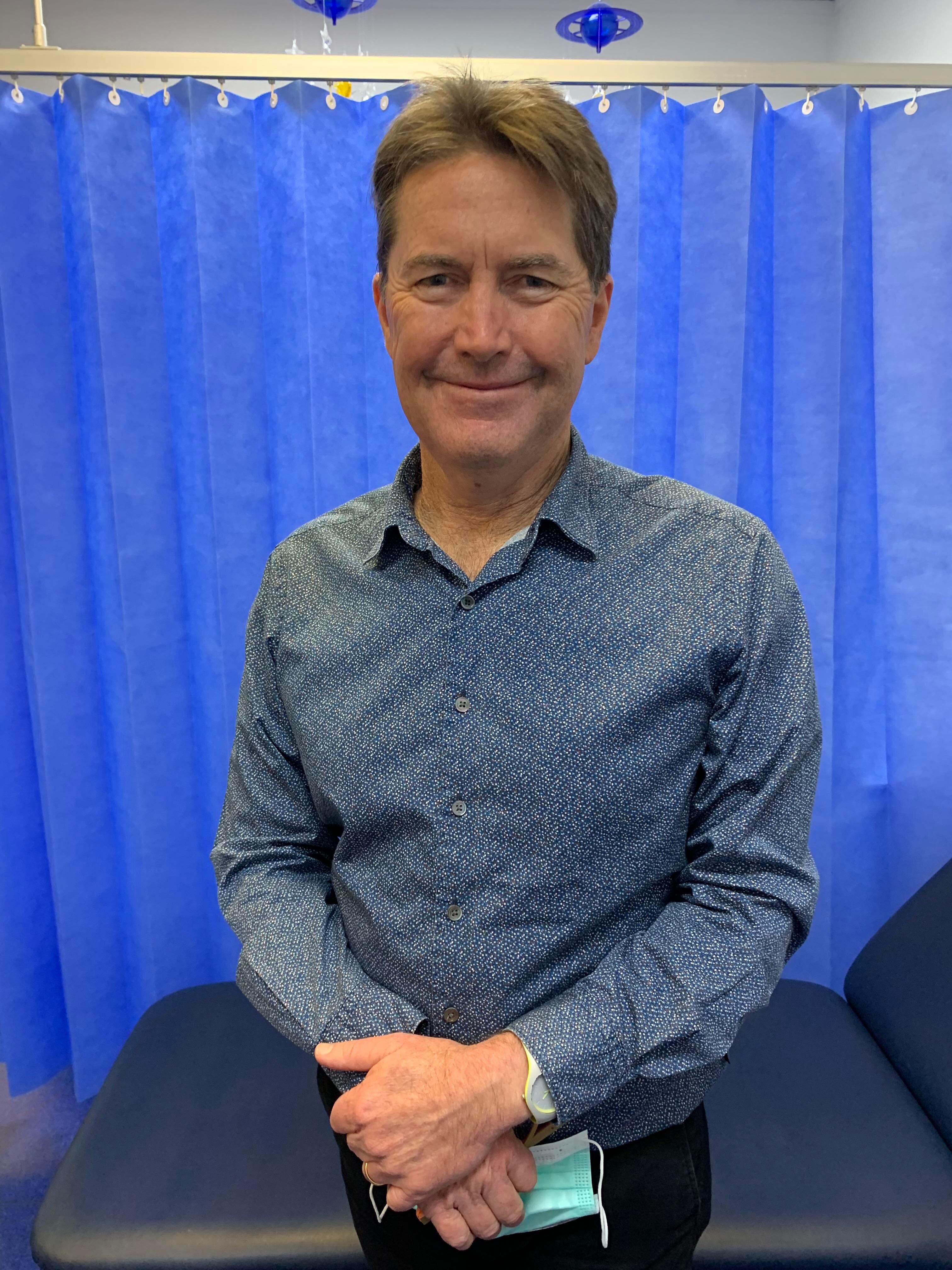 A man standing in a surgical waiting room