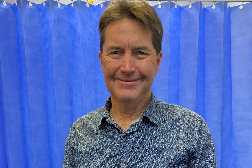 A man standing in a surgical waiting room