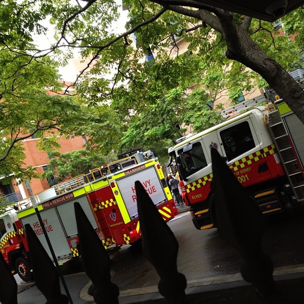 Fire trucks are parked outside an apartment block in Pyrmont where a car caught fire in the garage.