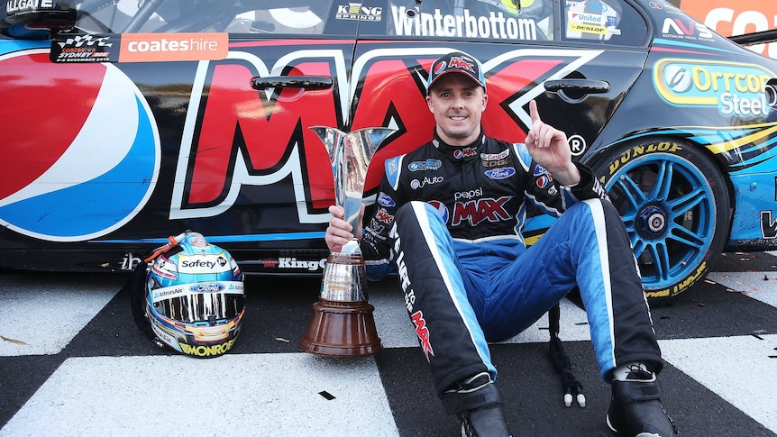 Ford's Mark Winterbottom poses with the V8 Supercar trophy after the Sydney 500 on December 6, 2015.