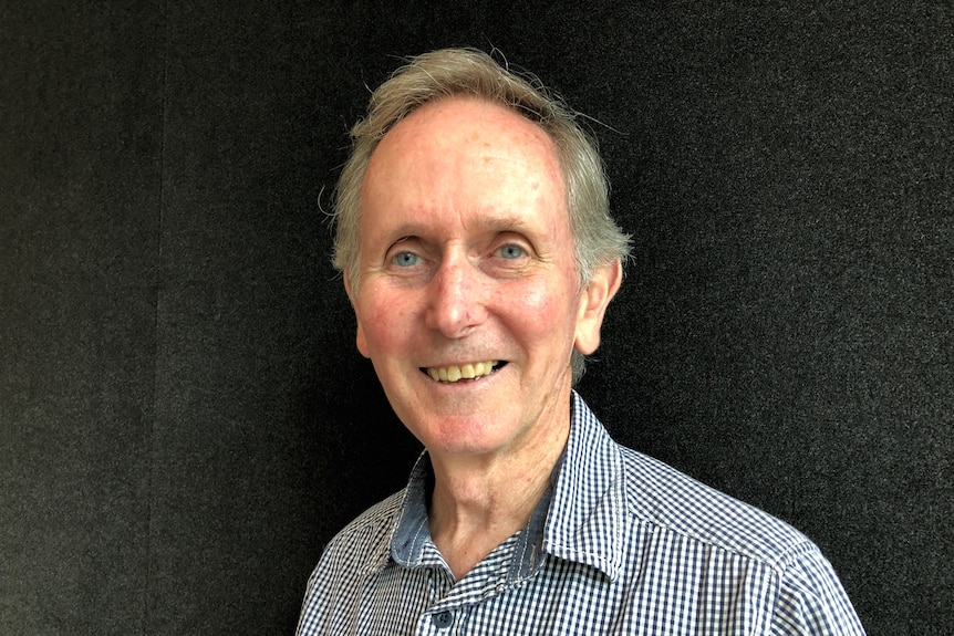 A smiling grey-haired man.