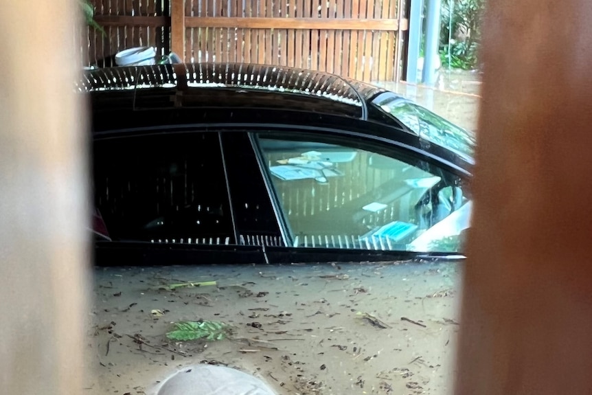 A black Audi submerged in floodwaters