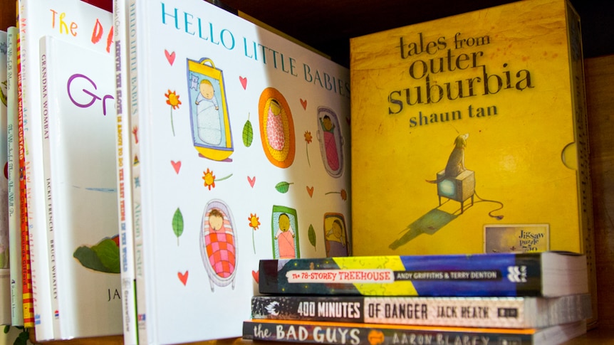 A collection of mostly Australian children's books sit on a bookshelf.