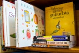 A collection of mostly Australian children's books sit on a bookshelf.