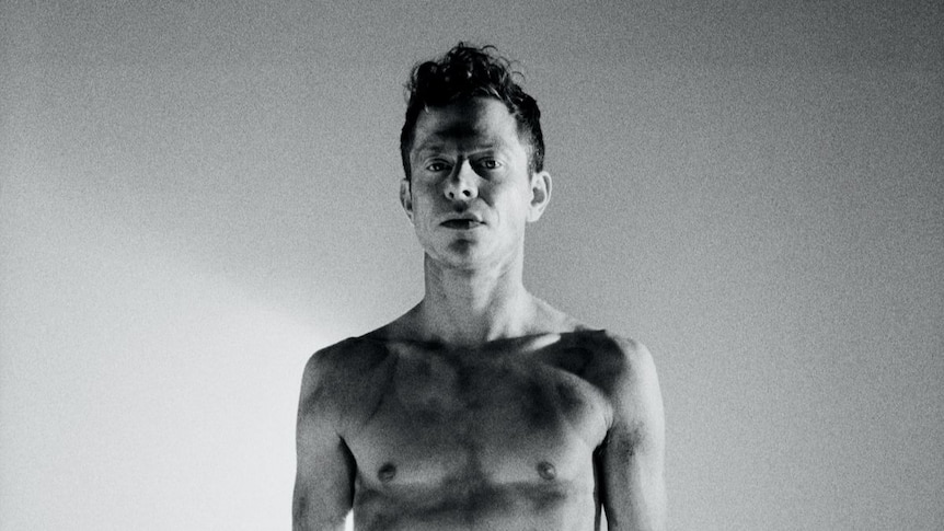 Black and white photo of a shirtless Mike Hadreas, aka Perfume Genius