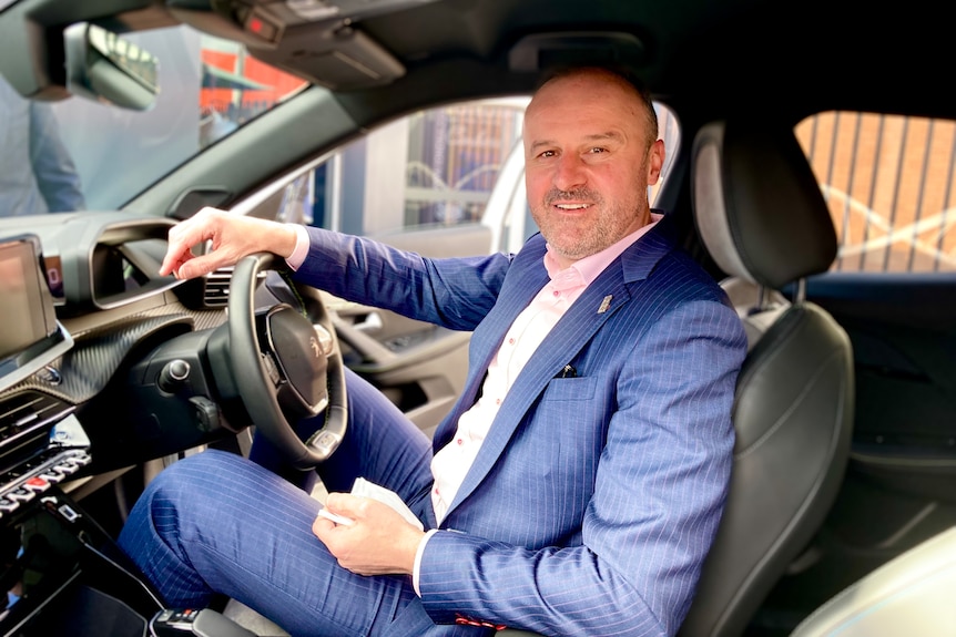 ACT Chief Minister Andrew Barr in the driver seat of a car.