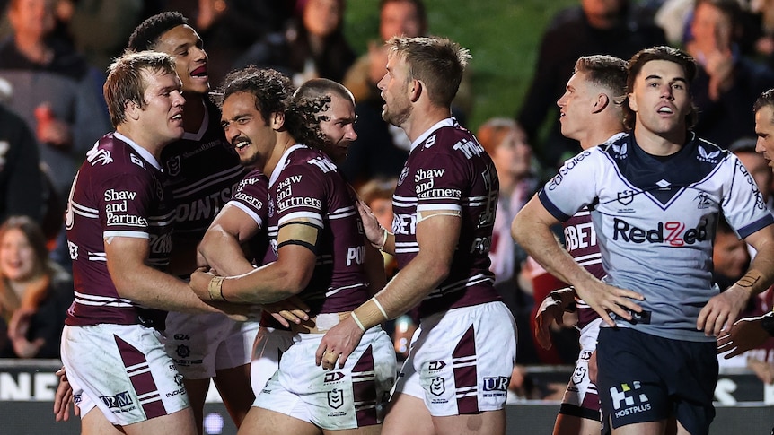 A group of rugby league players celebrate a try