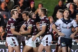 A group of rugby league players celebrate a try