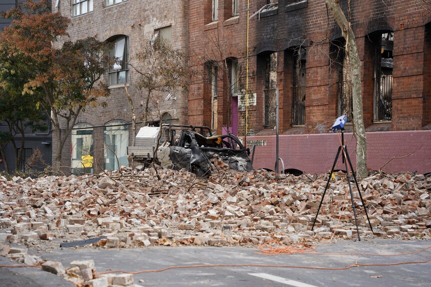 debris on the ground after a huge fie destroyed a historic building in sydney