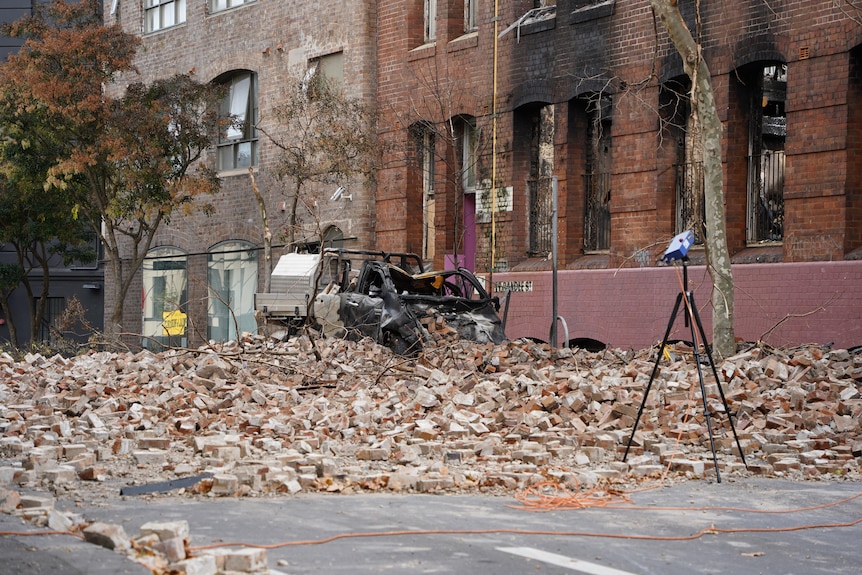 debris on the ground after a huge fie destroyed a historic building in sydney