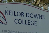 A sign reads 'Keilor Downs College', behind a school gate.