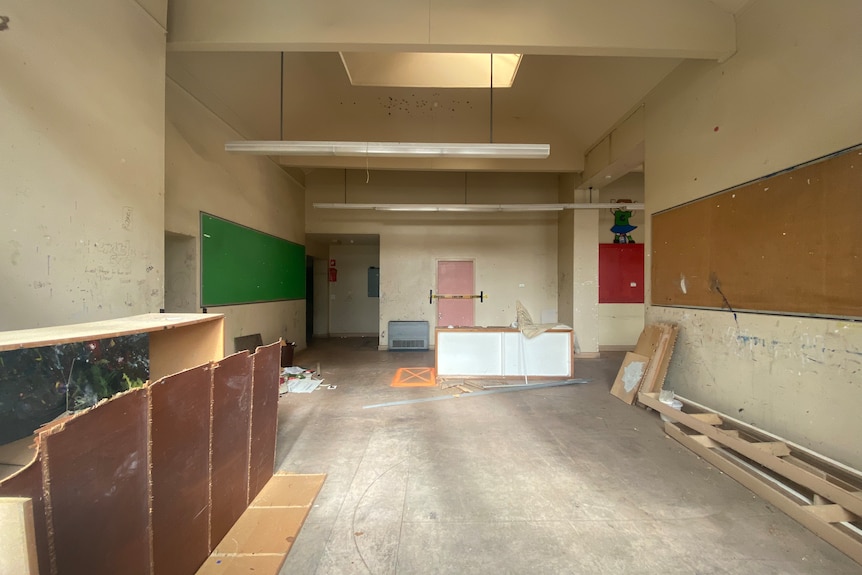 The inside of an old, disused school building.