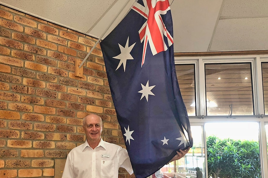 Kingscliff parish priest Paul McDonald displays his Australian flag
