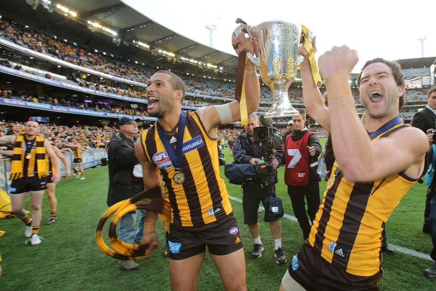 Josh Gibson and Jordan Lewis celebrate Hawthorn's grand final win in 2013.