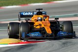 A McLaren Formula One car takes a turn in pre-season testing.