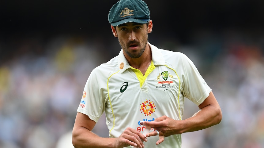 Australia bowler Mitchell Starc wraps strapping around his finger during a Test against South Africa.
