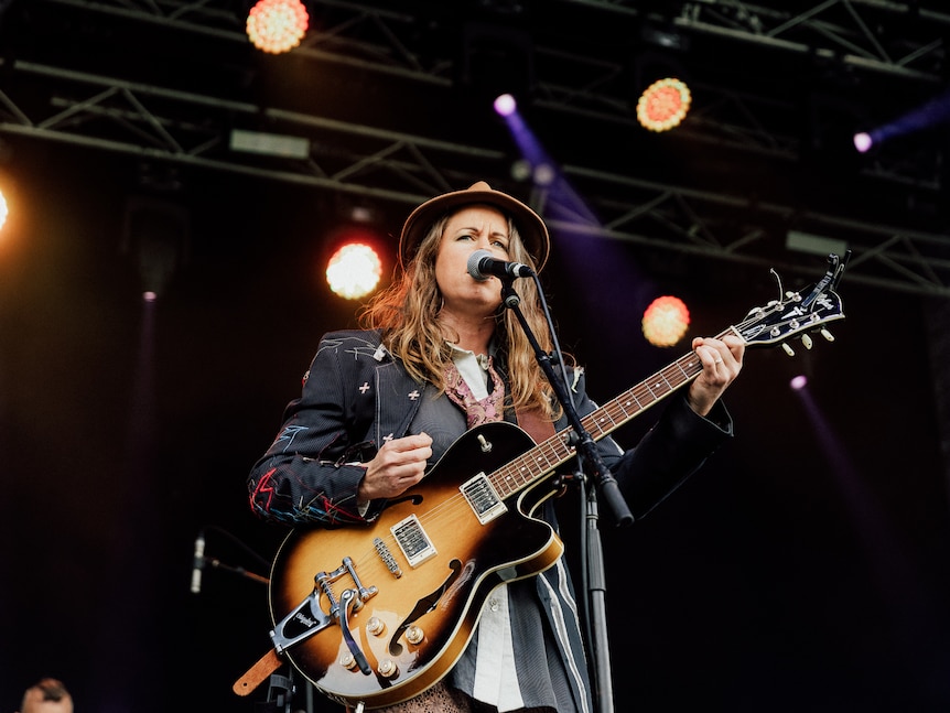 a woman playing a guitar