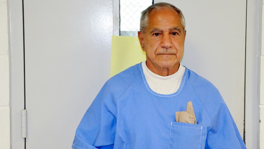 Sirhan Sirhan arrives for a parole wearing blue with a white shirt underneath.