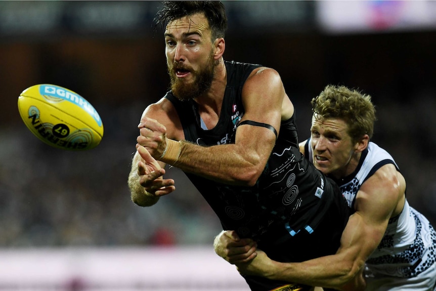 Charlie Dixon of Port Adelaide is tackled.