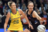 Caitlin Bassett of Australia contests the ball with Kelly Jury of New Zealand.