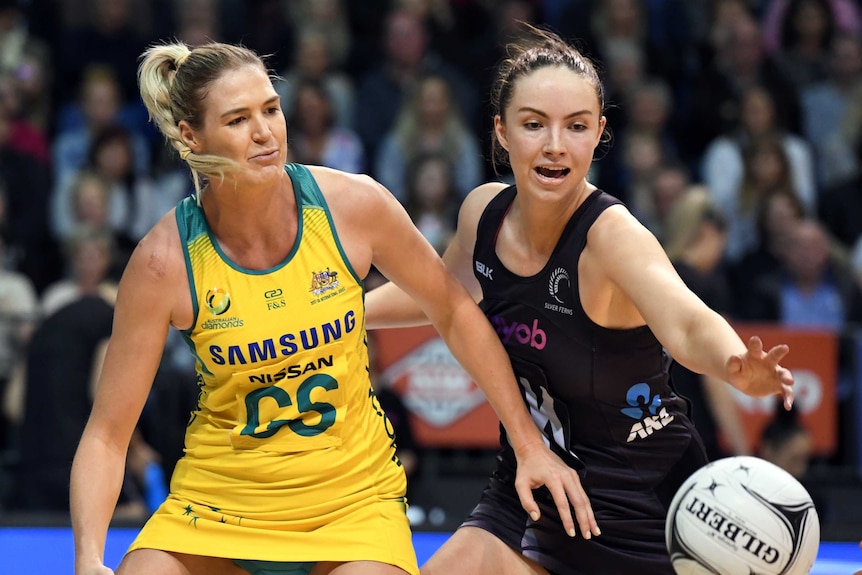 Caitlin Bassett of Australia contests the ball with Kelly Jury of New Zealand.