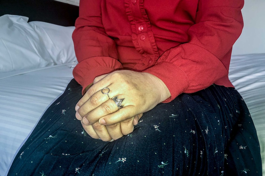 An unidentified woman's hands clasped
