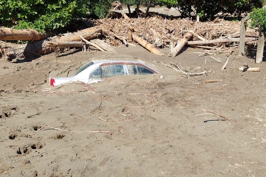 A car submerged in mud.