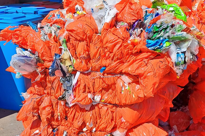 orange bale of plastic tied together with string 
