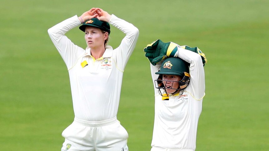 Australia's Meg Lanning (left) and Alyssa Healy (right) put their hands on their heads while fielding in the Women's Ashes Test.