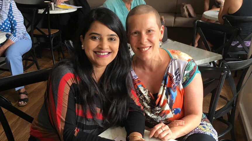 Two women sitting together in a restaurant.