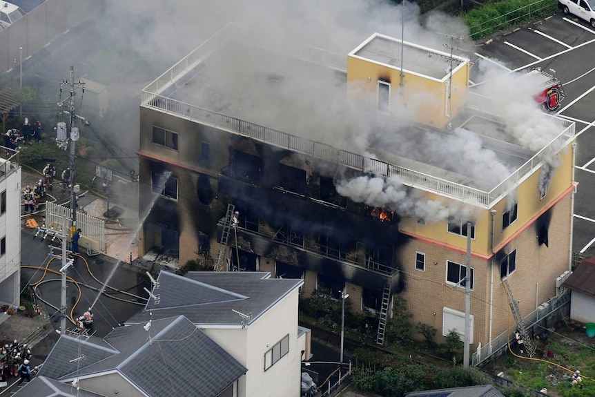 A view from above of a building engulfed in smoke.