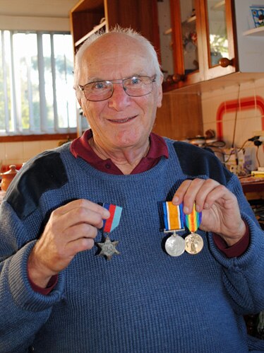 Wayne Smith holds war medals
