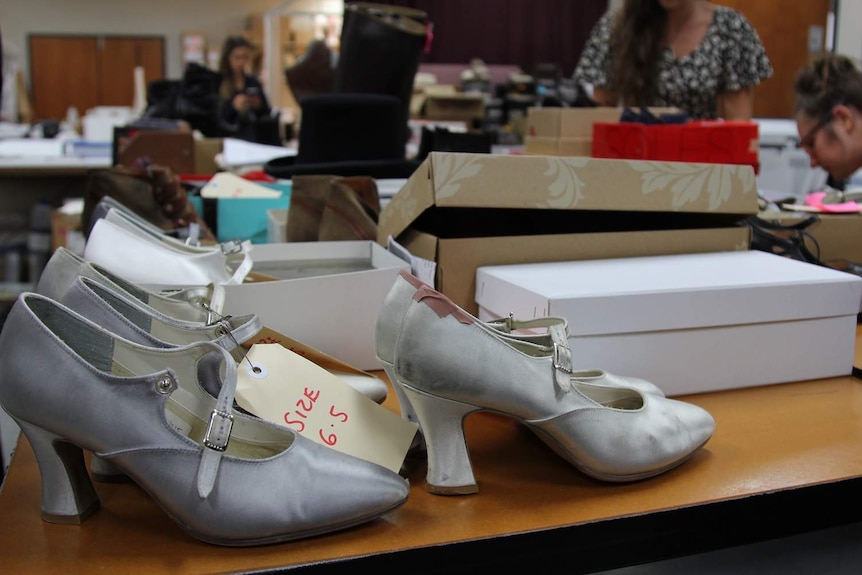 Stacks of shoes and boxes in a dressing room