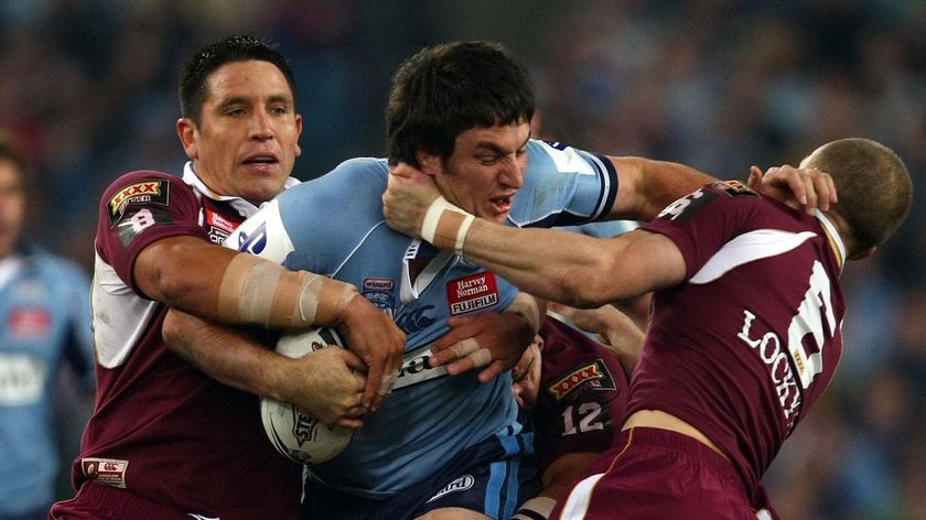 Brutal encounter ... Nathan Hindmarsh is tackled by Steve Price and Darren Lockyer