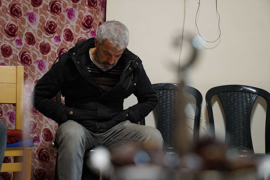 A male relative bows his head as he mourns Aiia Maasarwe in Israel.