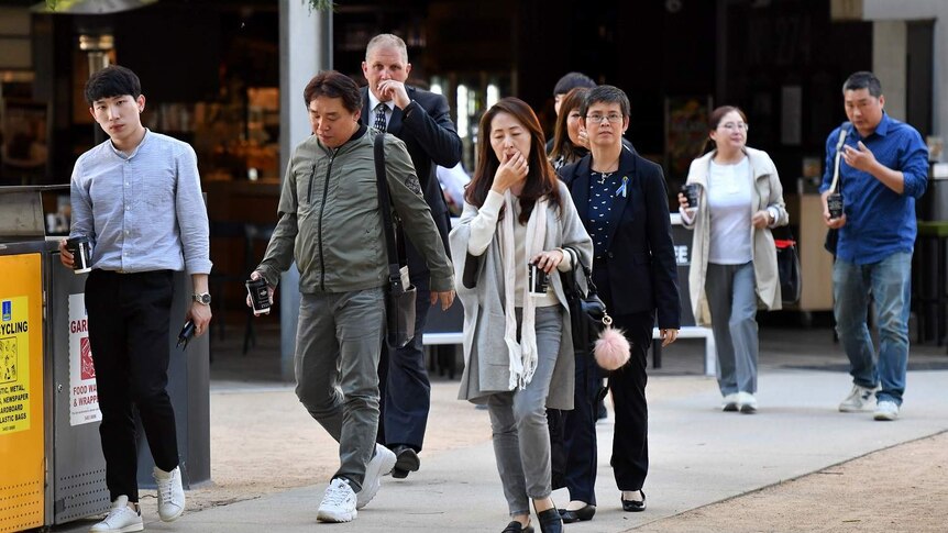 Family and friends of murdered South Korean student Eunji Ban are seen outside the Supreme Court in Brisbane