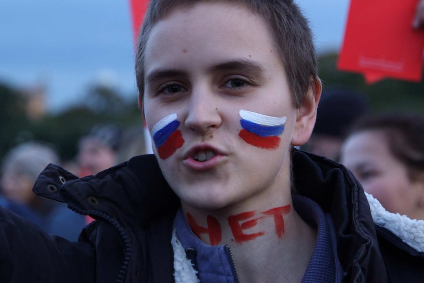 Woman with Russian flag face paint on her cheeks