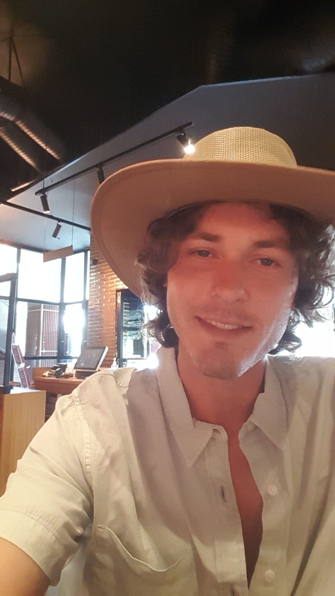 A selfie of a young man wearing a hat