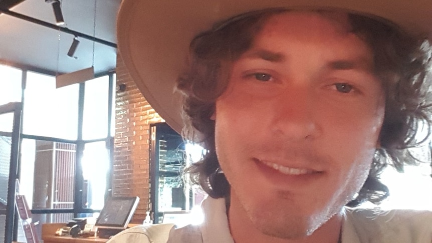 A selfie of a young man wearing a hat