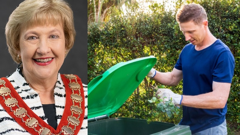 smiling older lady with blonde bob and council uniform and man putting plants into green bin