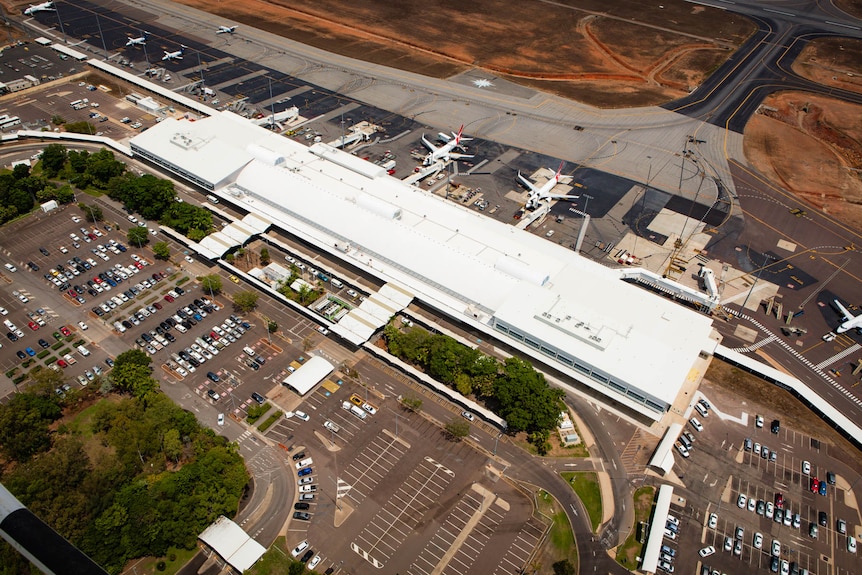 An aerial photo of an airport with planes at the apron.