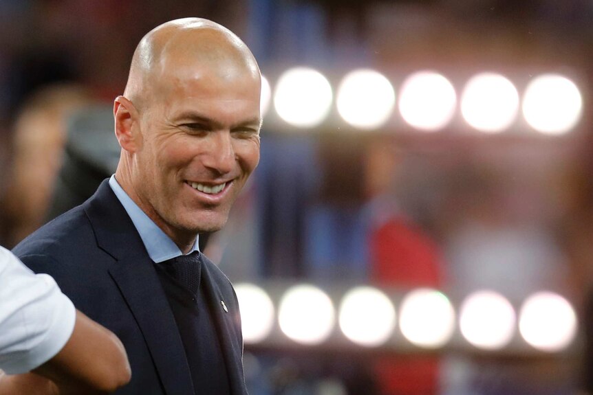 Zidane smiling.