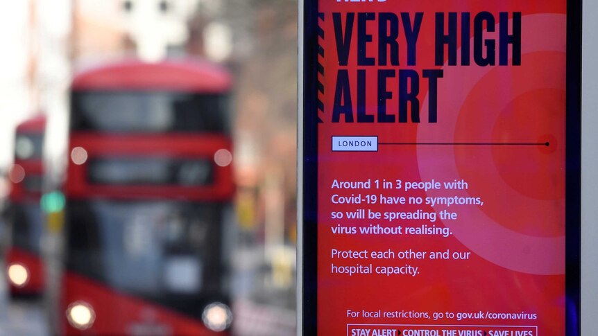 A red sign reading 'very high alert' with red double decker bus in the background.