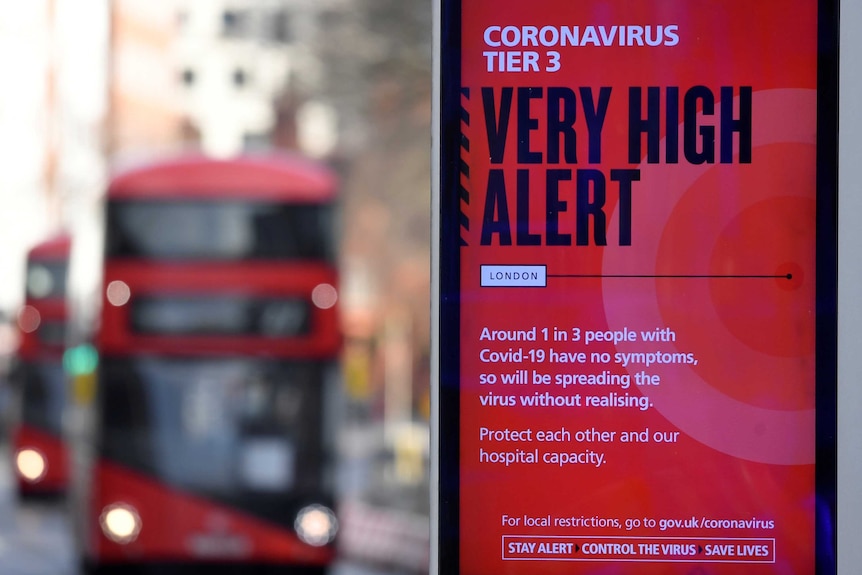 A red sign reading 'very high alert' with red double decker bus in the background.