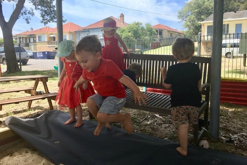 Kids play in a sandpit at Hamilton South Community Playgroup near Newcastle.