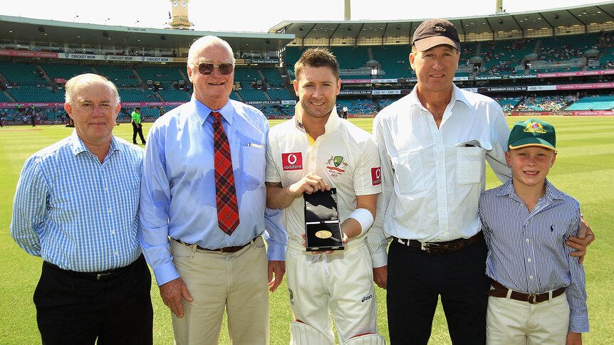 Michael Clarke is presented with the Allan McGilvray Medal with ABC Grandstand's Jim Maxwell (l) Ross McGilvray (2nd L) Angus McGilvray (2nd R) and Matt McGilvray (R).