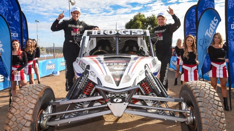 Shannon and Ian Rentsch sit on top of their car.