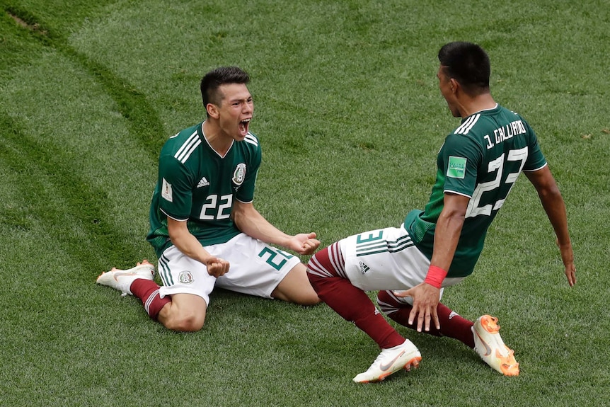 Mexico's Hirving Lozano slides along the grass on his knees after scoring